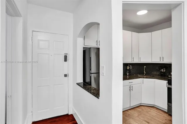 a kitchen with a refrigerator and cabinets