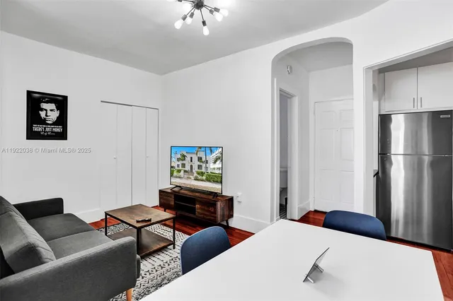 a bedroom with a bed couch and a window