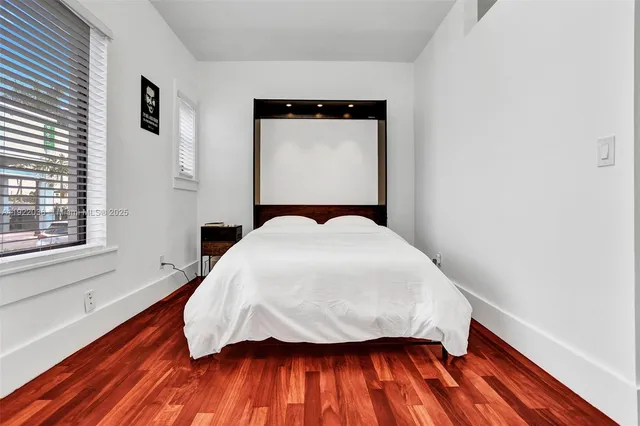 a bed sitting in a bedroom next to a window