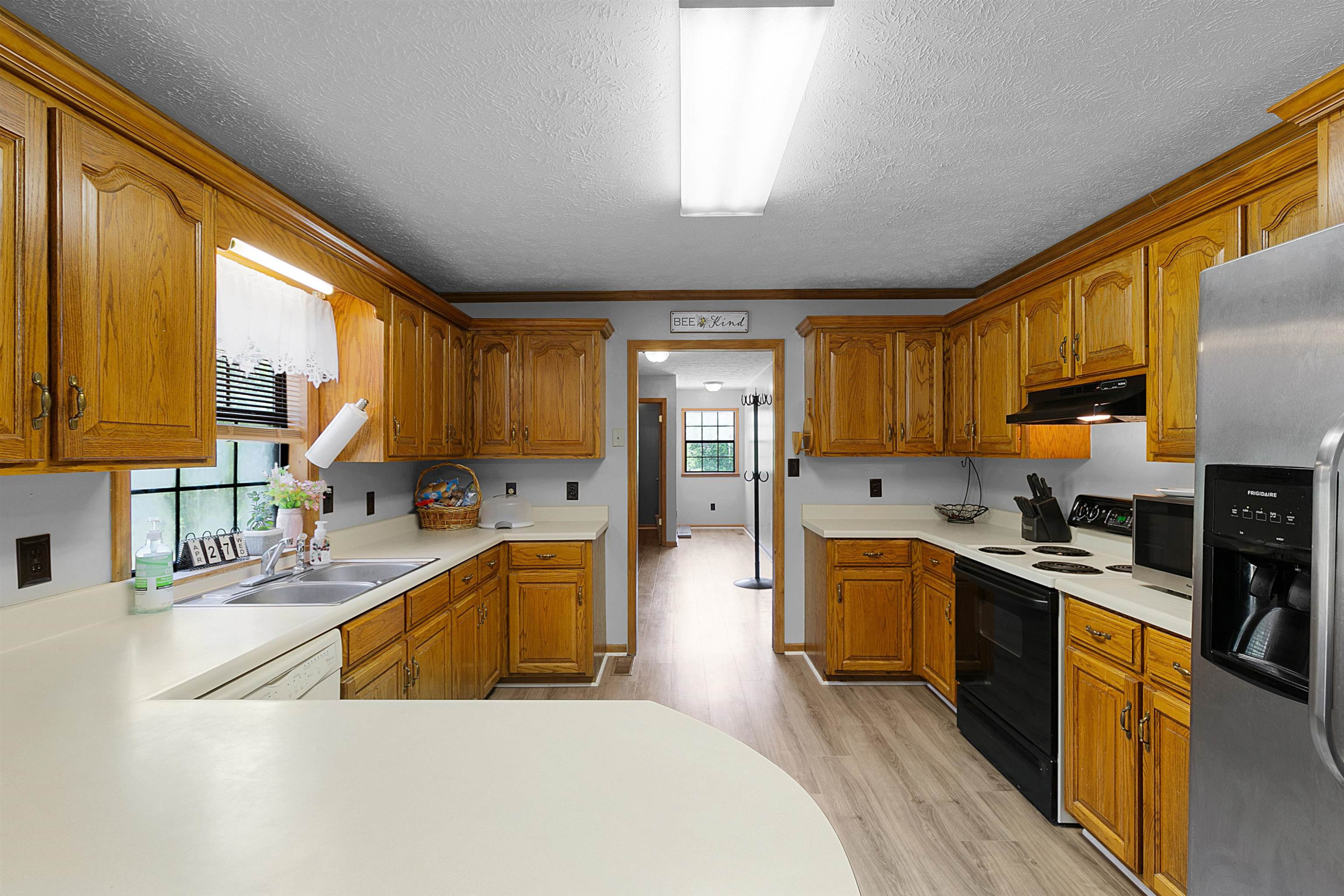 475 Liberty Claybrook Road Beech Bluff, TN 38313 - Photo 7 of 18 a large kitchen with stainless steel appliances granite countertop a sink a stove cabinets counter space and a window
