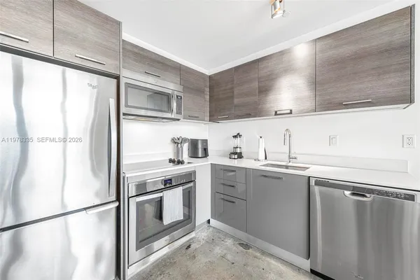 a kitchen with a sink window and cabinets