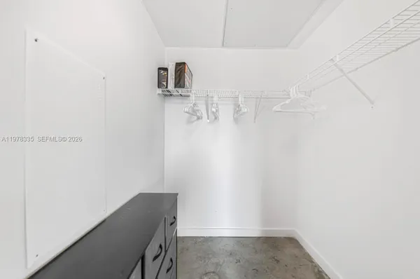 a view of storage and utility room with two washing machine