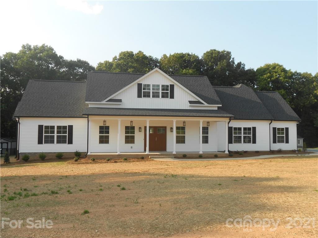 2309 New Salem Road Monroe, NC 28110 - Photo 1 of 26 a front view of a house with a garden