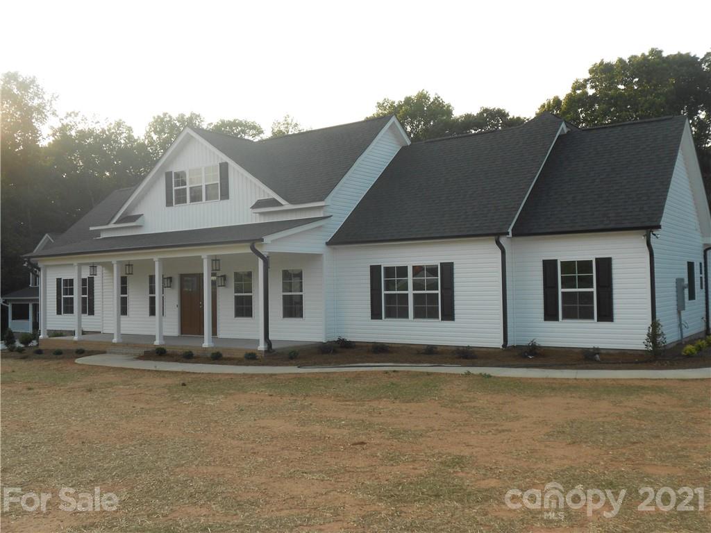 2309 New Salem Road Monroe, NC 28110 - Photo 2 of 26 a front view of a house with garden