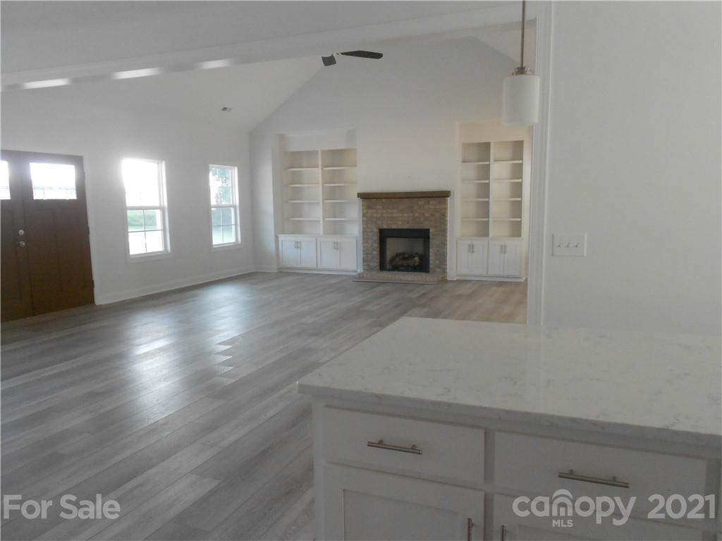 2309 New Salem Road Monroe, NC 28110 - Photo 11 of 26 a view of empty room with wooden floor and fireplace