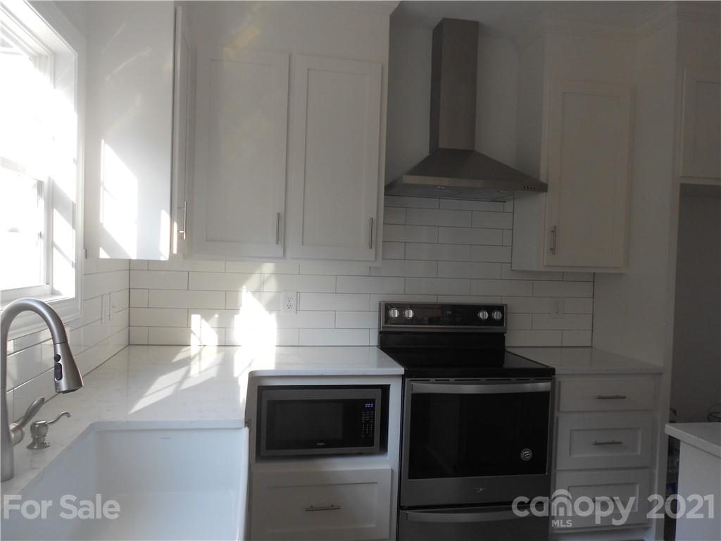 2309 New Salem Road Monroe, NC 28110 - Photo 16 of 26 a kitchen with a stove and a sink