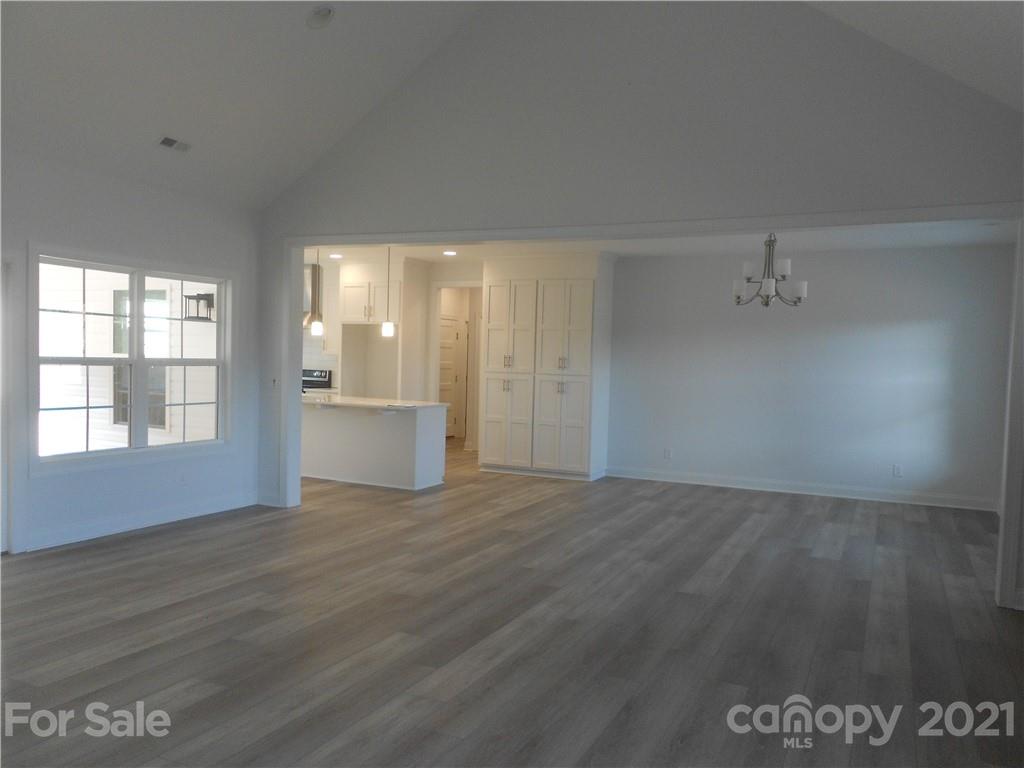 2309 New Salem Road Monroe, NC 28110 - Photo 19 of 26 an empty room with wooden floor and windows