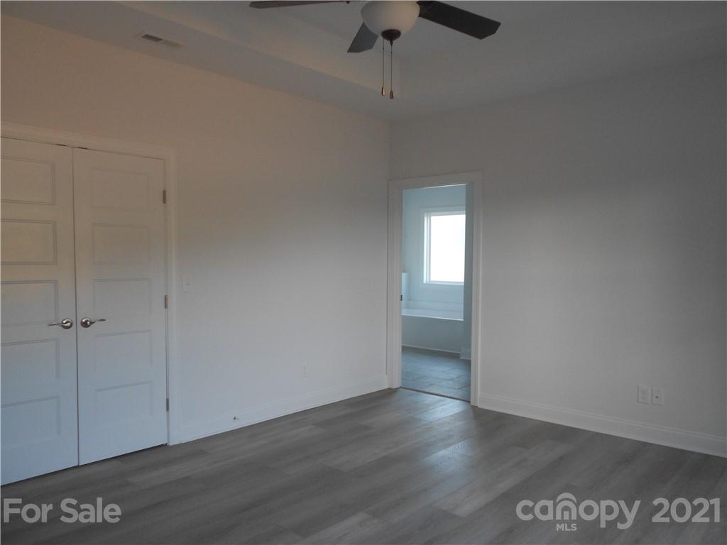 2309 New Salem Road Monroe, NC 28110 - Photo 20 of 26 an empty room with wooden floor and windows
