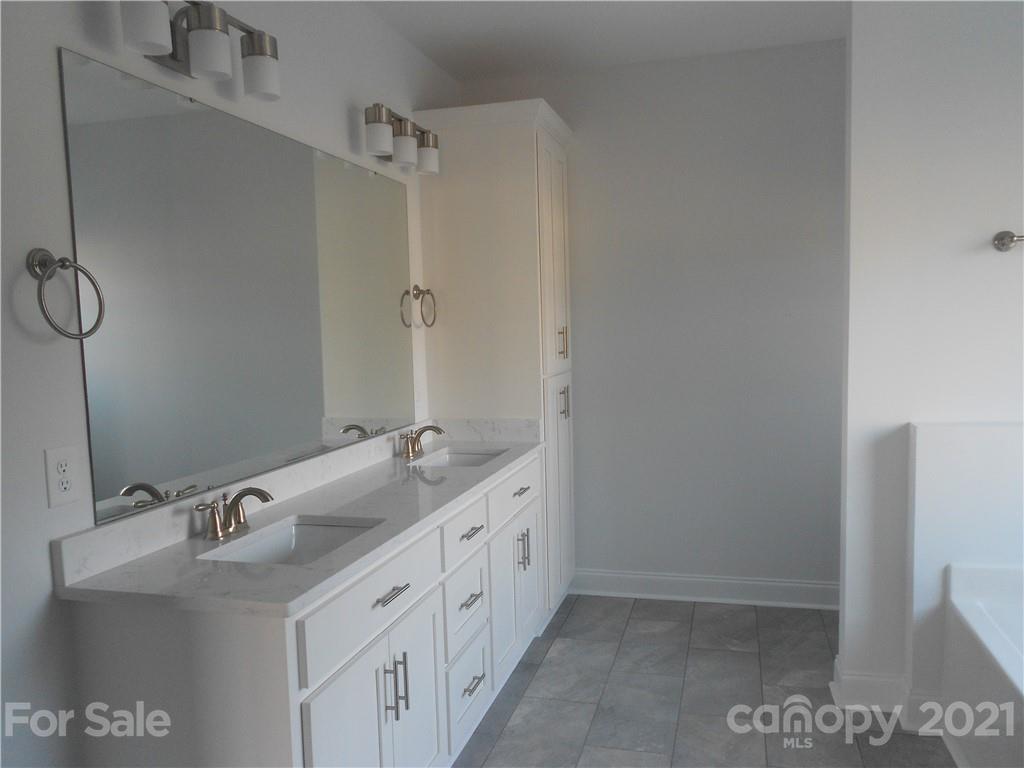 2309 New Salem Road Monroe, NC 28110 - Photo 21 of 26 a bathroom with a double vanity sink and mirror