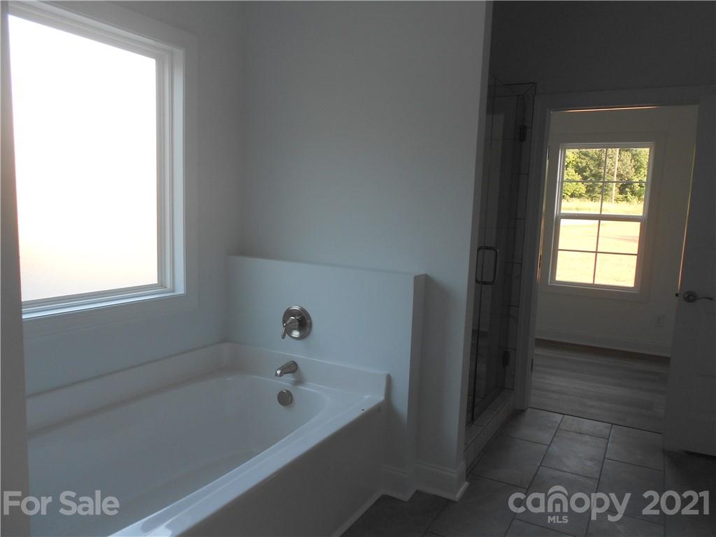 2309 New Salem Road Monroe, NC 28110 - Photo 22 of 26 a bathroom with a bathtub and a window