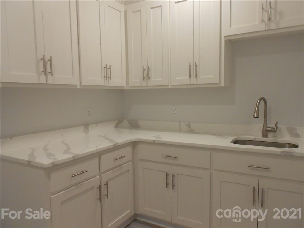 2309 New Salem Road Monroe, NC 28110 - Photo 24 of 26 a kitchen with white cabinets