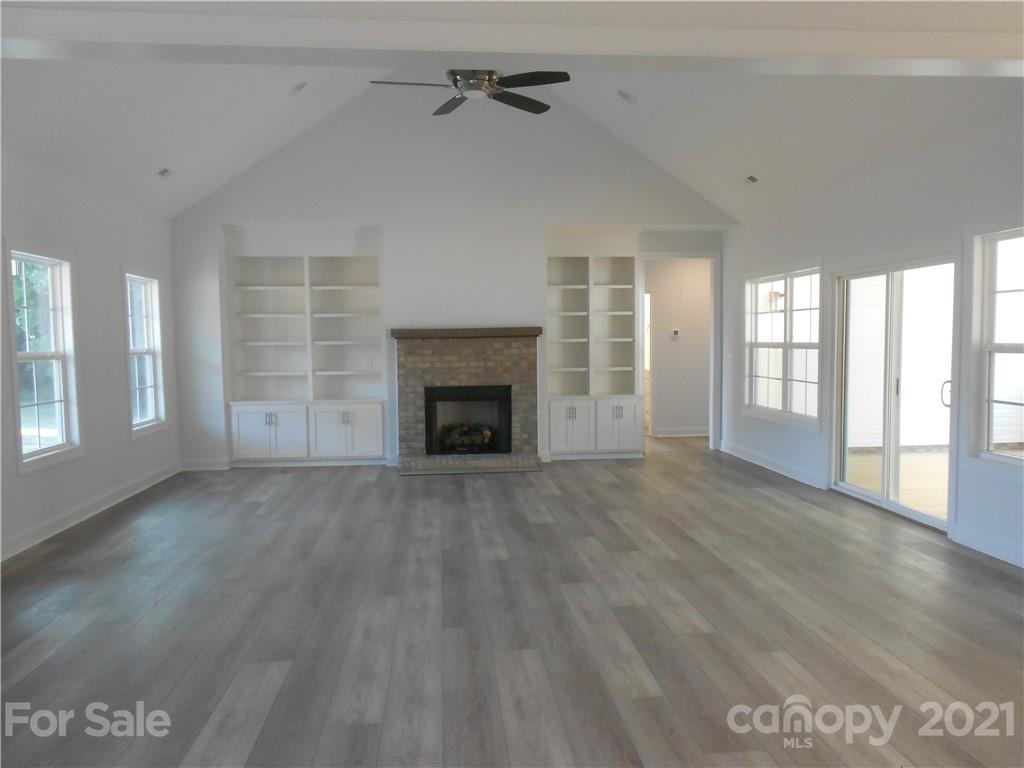 2309 New Salem Road Monroe, NC 28110 - Photo 8 of 26 an empty room with windows and fireplace