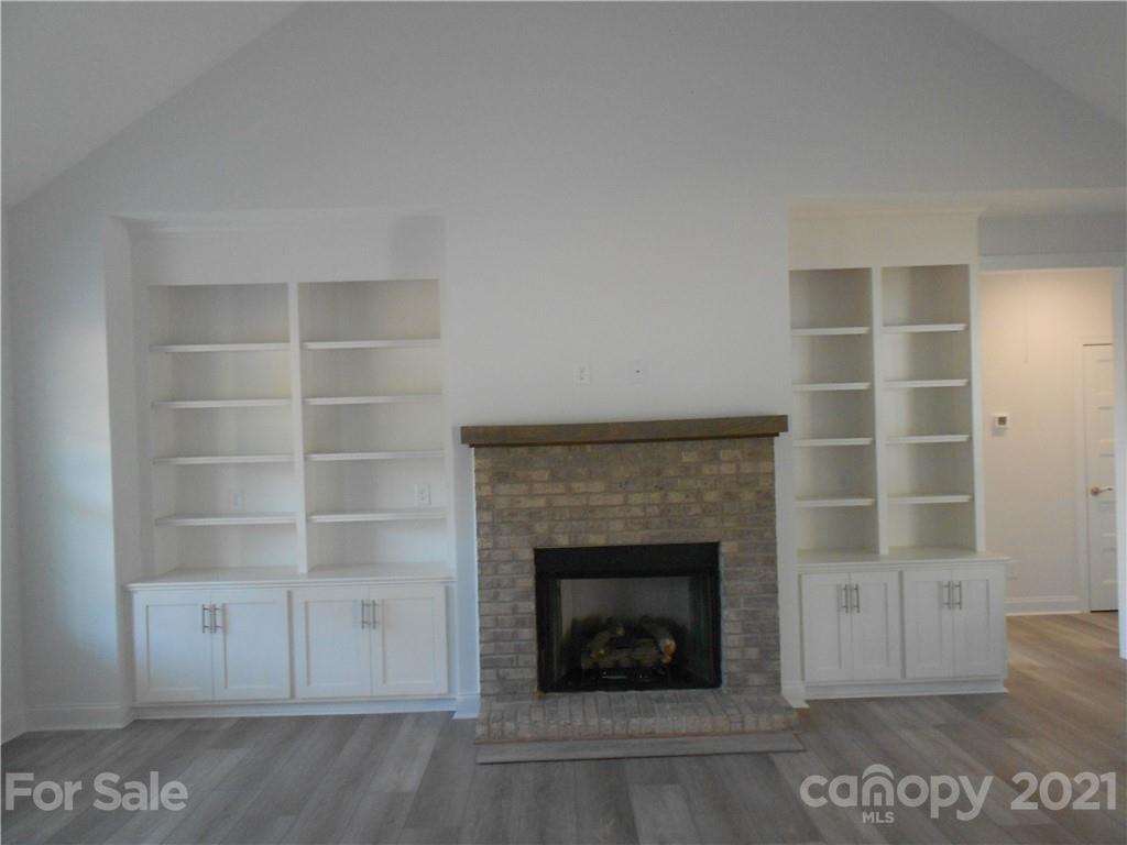 2309 New Salem Road Monroe, NC 28110 - Photo 9 of 26 a living room with a fireplace and a rug