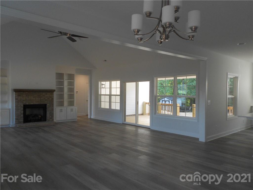 2309 New Salem Road Monroe, NC 28110 - Photo 10 of 26 a view of an empty room with wooden floor fireplace and a window