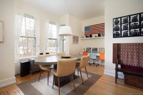 a dining room with furniture a rug and wooden floor