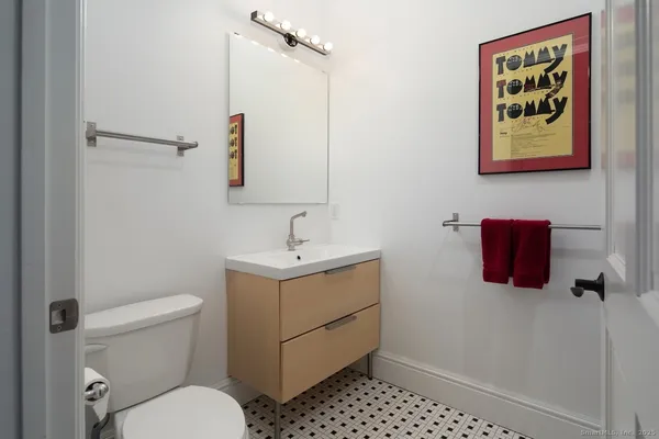 a bathroom with a toilet sink and mirror