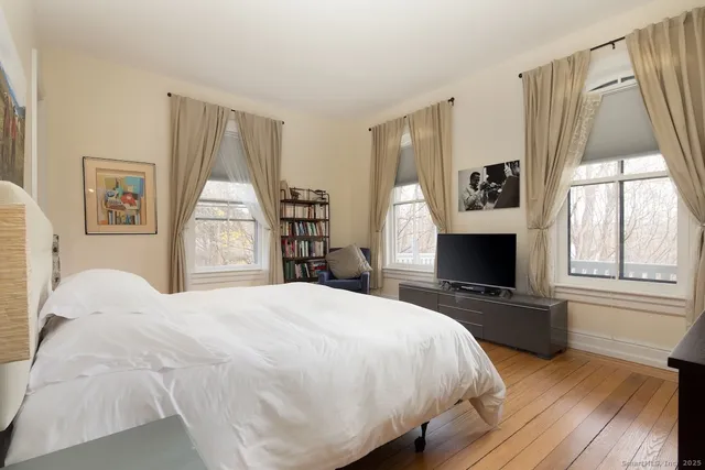 a bedroom with a bed and a fireplace