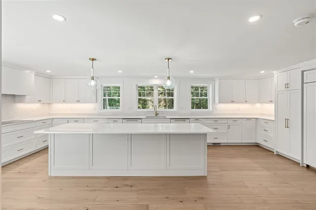 a view of an empty room with a fireplace and a window