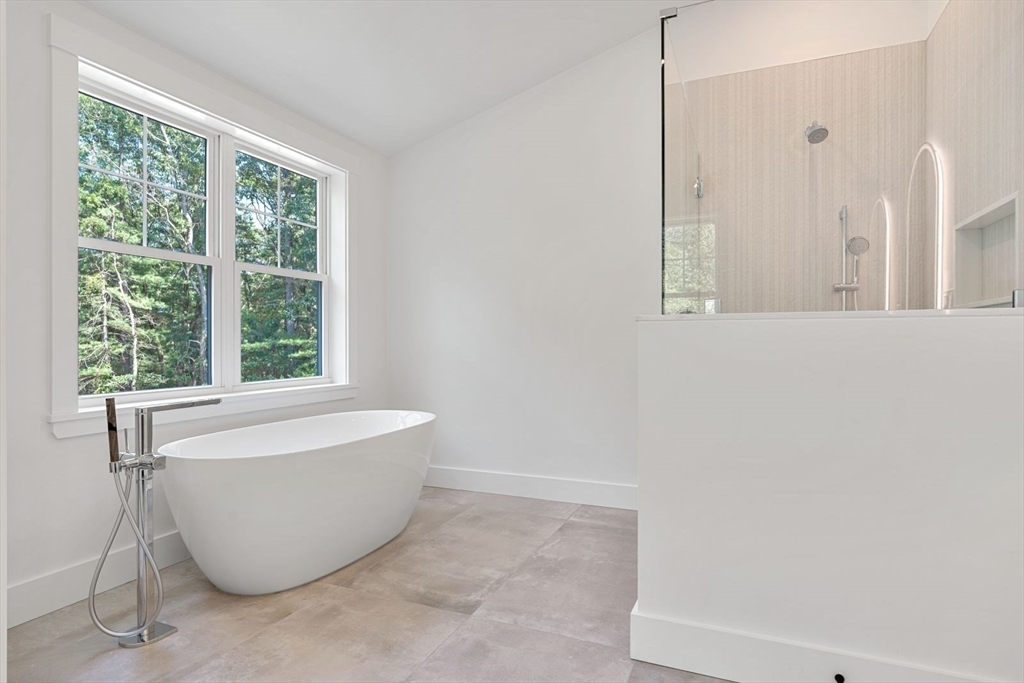 14 Ruel Drive Dover, MA 02030 - Photo 23 of 41 a white bath tub sitting in a bathroom next to a window