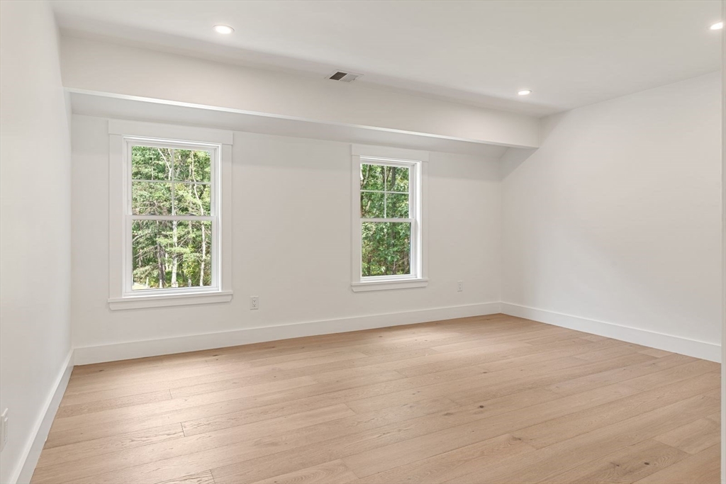 14 Ruel Drive Dover, MA 02030 - Photo 26 of 41 an empty room with wooden floor and windows