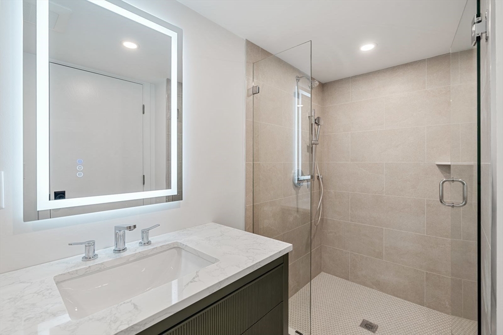 14 Ruel Drive Dover, MA 02030 - Photo 29 of 41 a bathroom with a sink a toilet a shower and a mirror