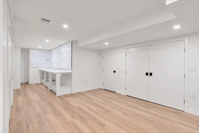 a kitchen with sink and mirror