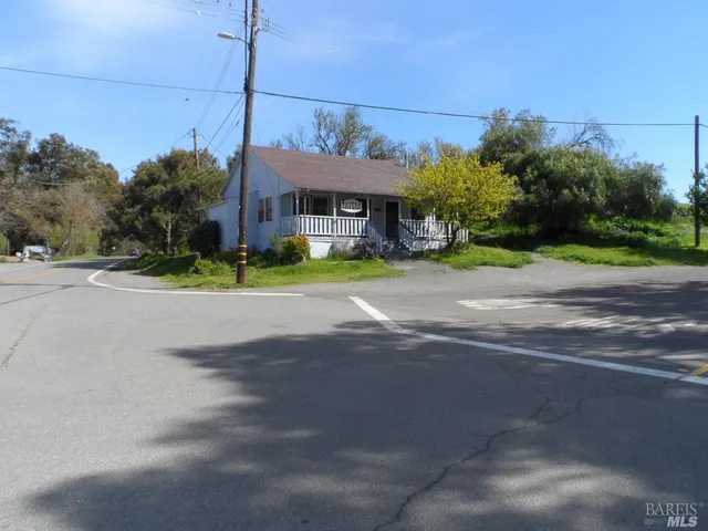 a yellow house with trees in front of it