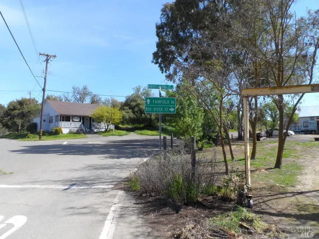 a front view of a house with a yard and tree s
