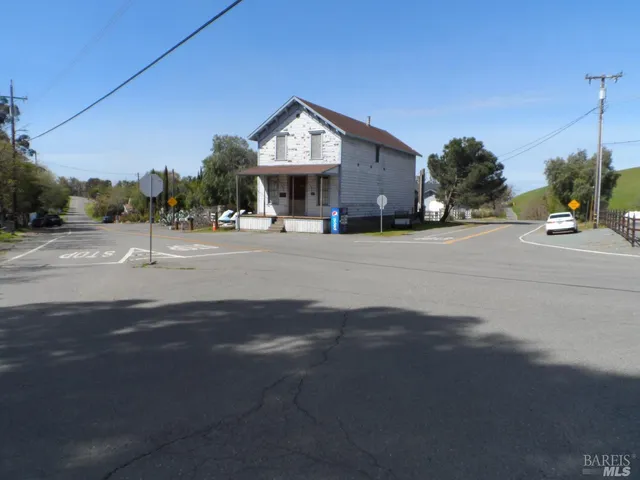 a front view of a building with a yard