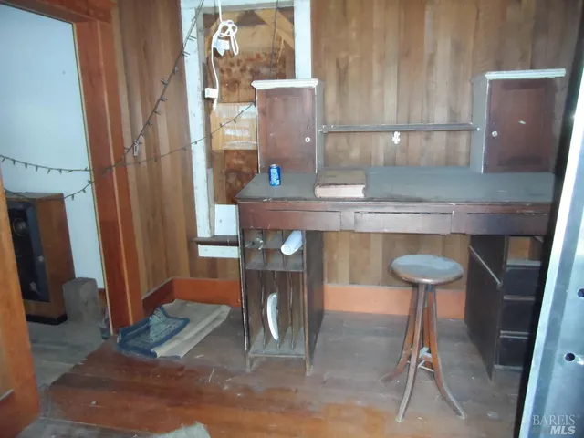 a view of a room with a table and chairs