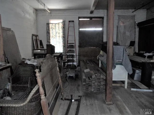 a view of a livingroom with furniture and a flat screen tv