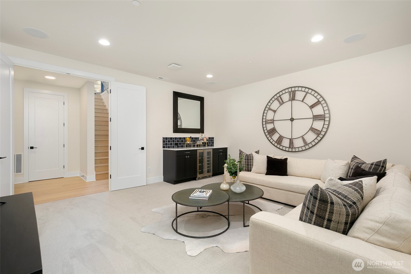 308 124th Place Northeast Bellevue, WA 98005 - Photo 31 of 39 a living room with furniture a clock and white walls