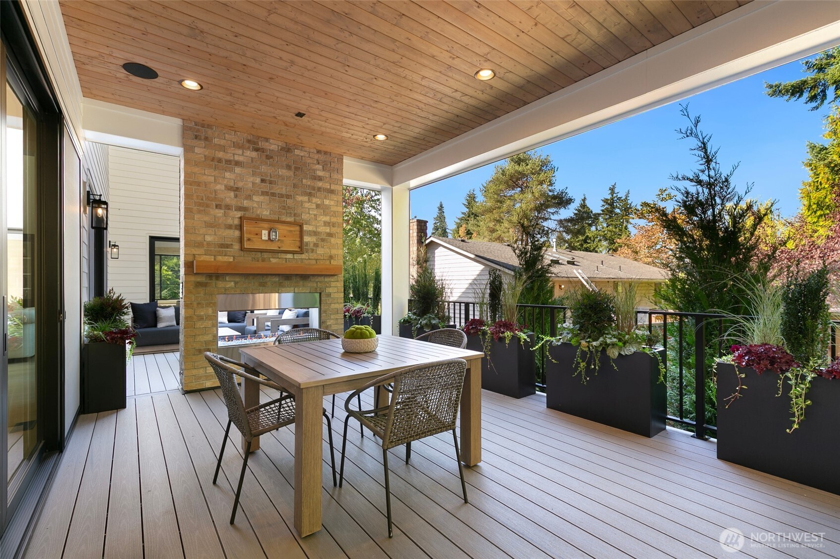 308 124th Place Northeast Bellevue, WA 98005 - Photo 33 of 39 a view of a patio with table and chairs and potted plants with wooden floor