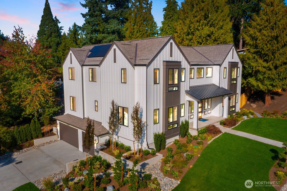308 124th Place Northeast Bellevue, WA 98005 - Photo 39 of 39 a view of a white house next to a yard with big trees