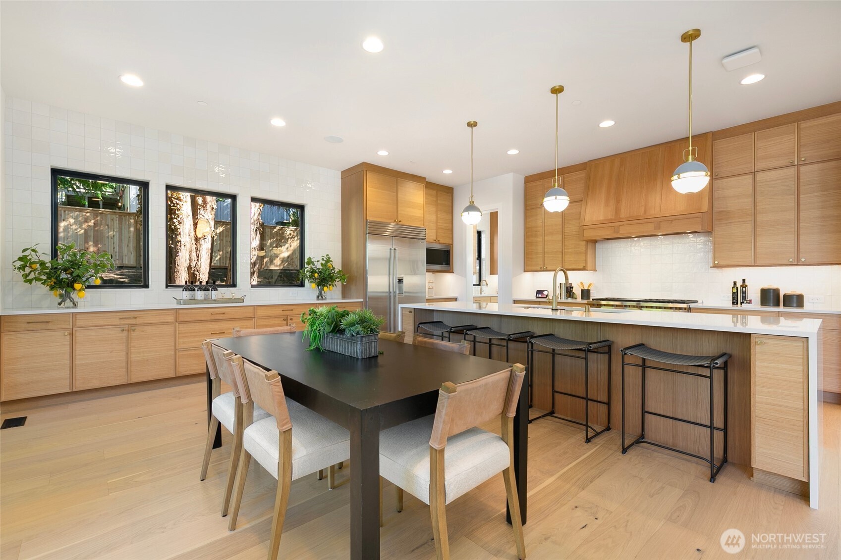 308 124th Place Northeast Bellevue, WA 98005 - Photo 8 of 39 a kitchen with a dining table chairs sink and cabinets
