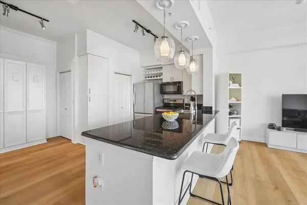 a kitchen with kitchen island a counter top space appliances and cabinets