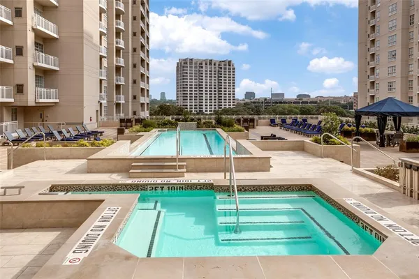 a view of a swimming pool with a lounge chairs