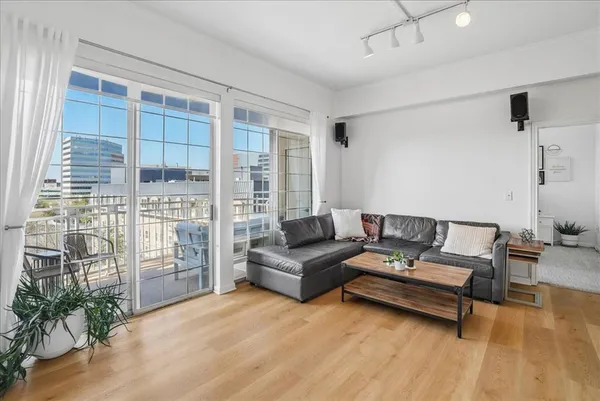 a living room with furniture and a floor to ceiling window