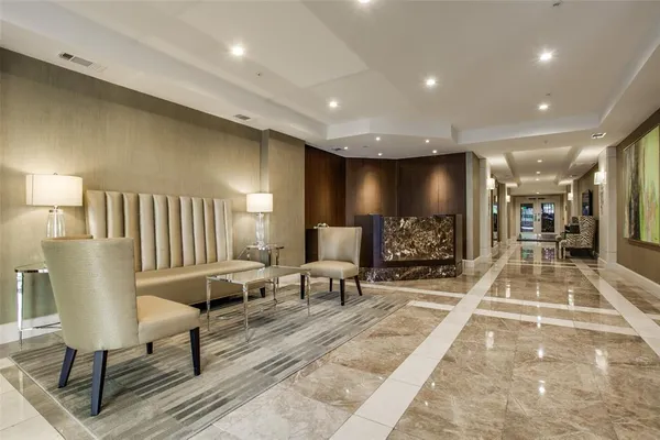 a lobby with furniture and a rug