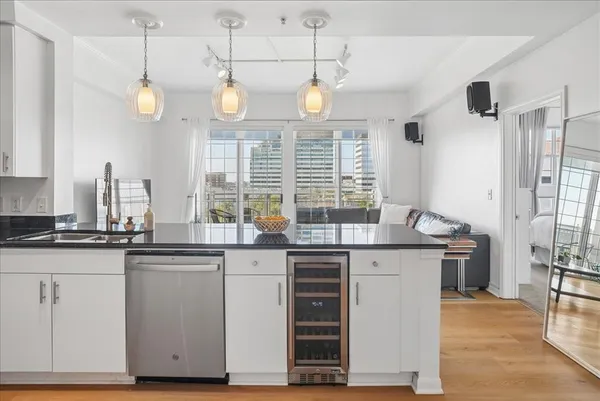 a kitchen with stainless steel appliances granite countertop a sink and cabinets