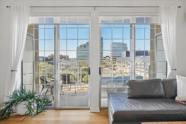 a living room with furniture and a floor to ceiling window