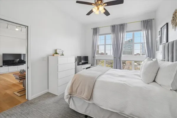 a bedroom with a bed and a chandelier