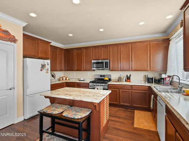 a bathroom with a granite countertop toilet sink and mirror