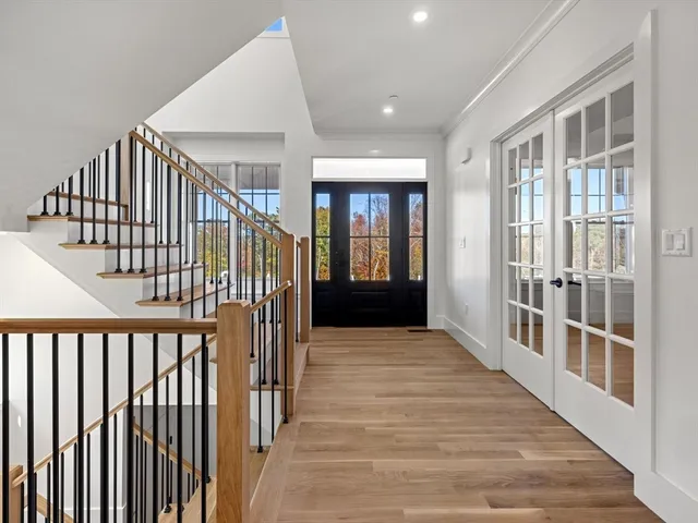 a view of entryway and hall with wooden floor