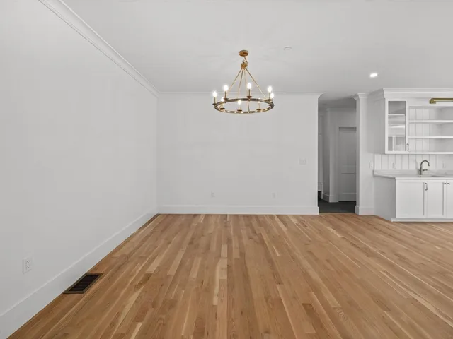 a kitchen with a stove sink and cabinets