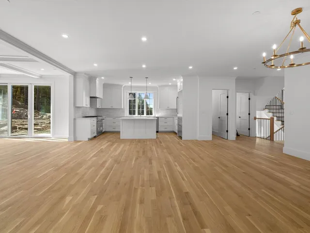 a view of empty room with wooden floor and windows