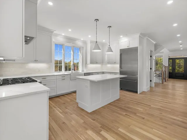 a room with granite countertop white cabinets and sink