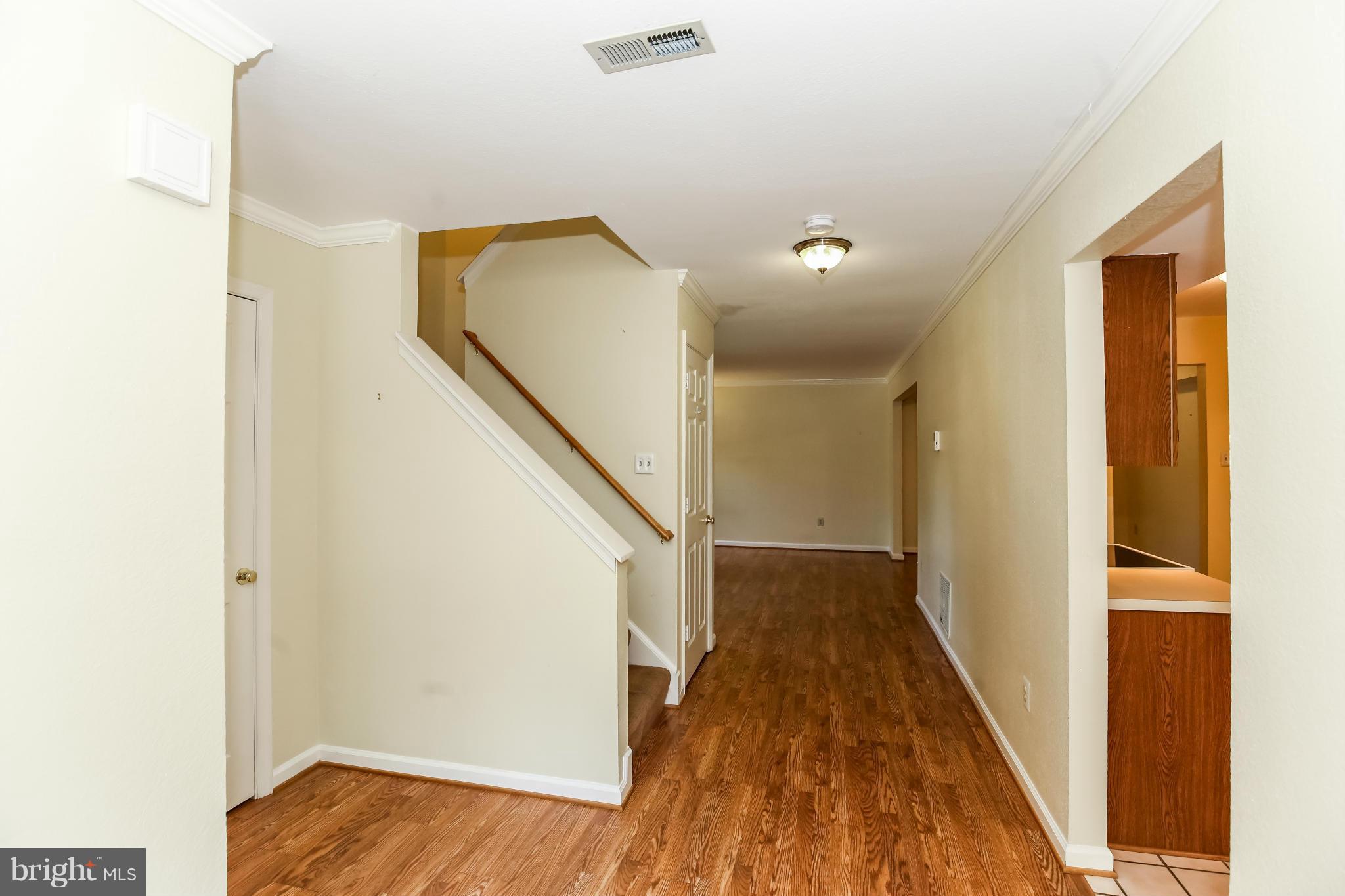 1748 Wilcox Lane Silver Spring, MD 20906 - Photo 3 of 19 a view of a hallway with wooden floor and staircase