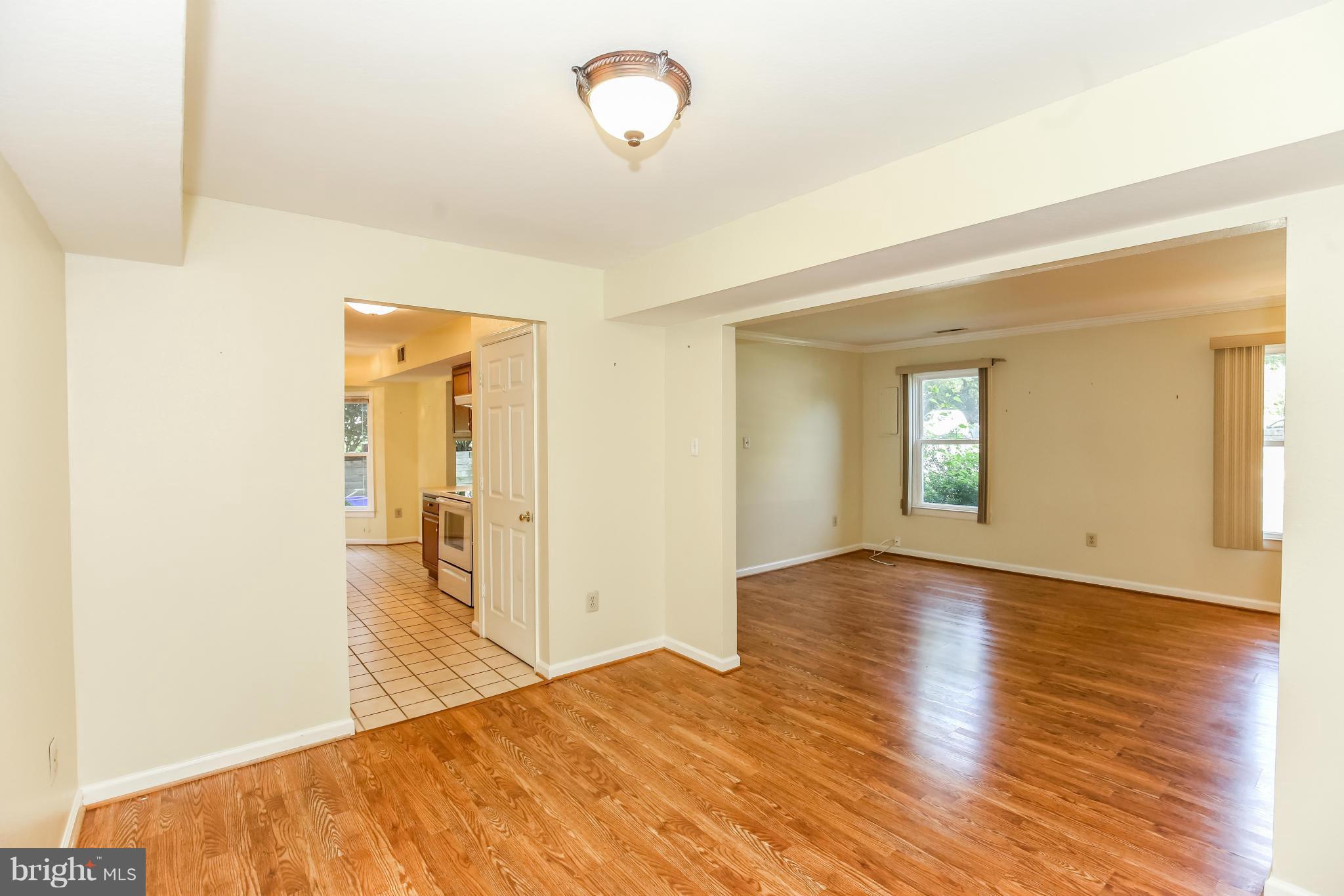 1748 Wilcox Lane Silver Spring, MD 20906 - Photo 5 of 19 a view of empty room with wooden floor and fan