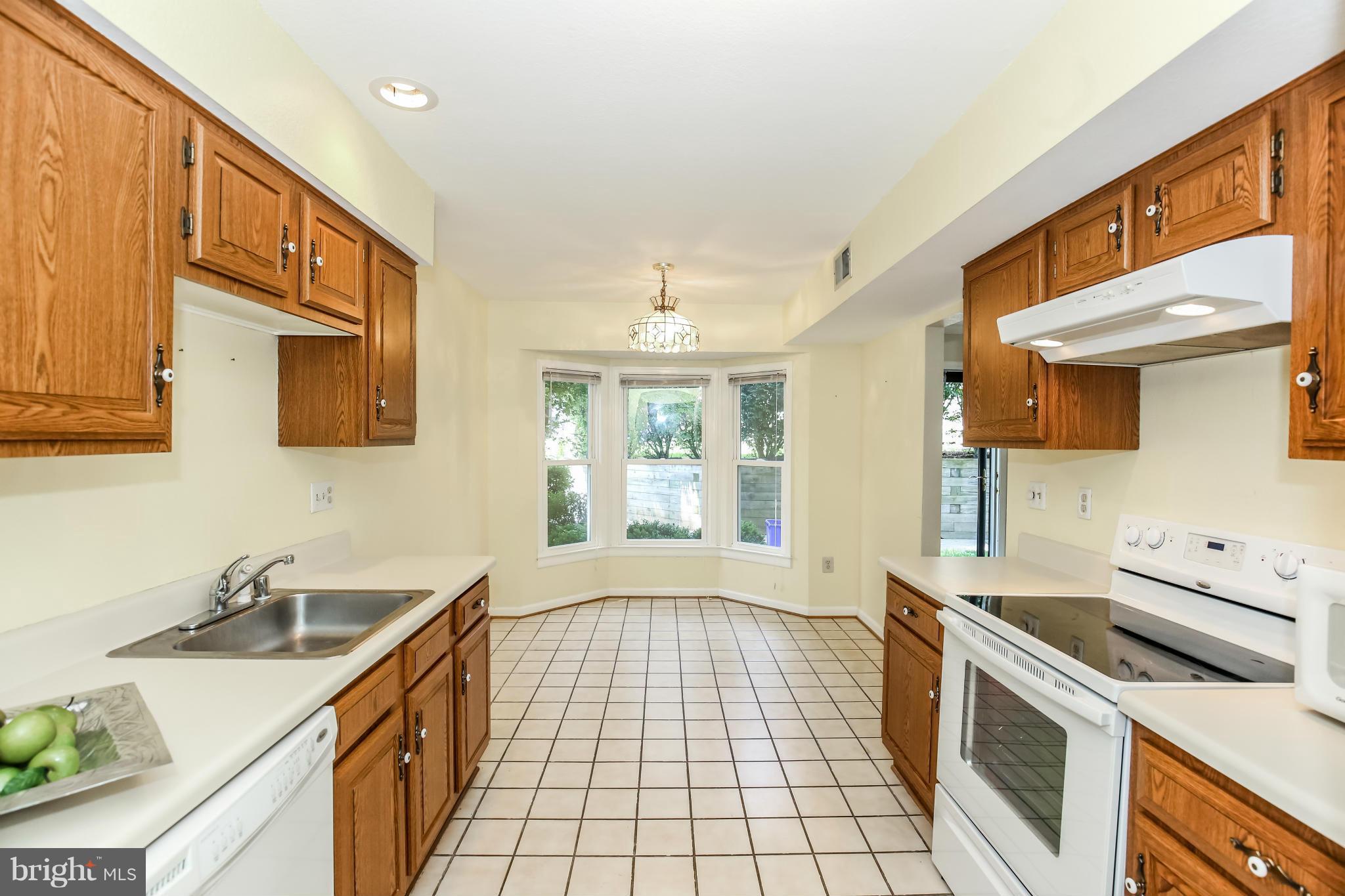 1748 Wilcox Lane Silver Spring, MD 20906 - Photo 7 of 19 a kitchen with a sink stove and cabinets